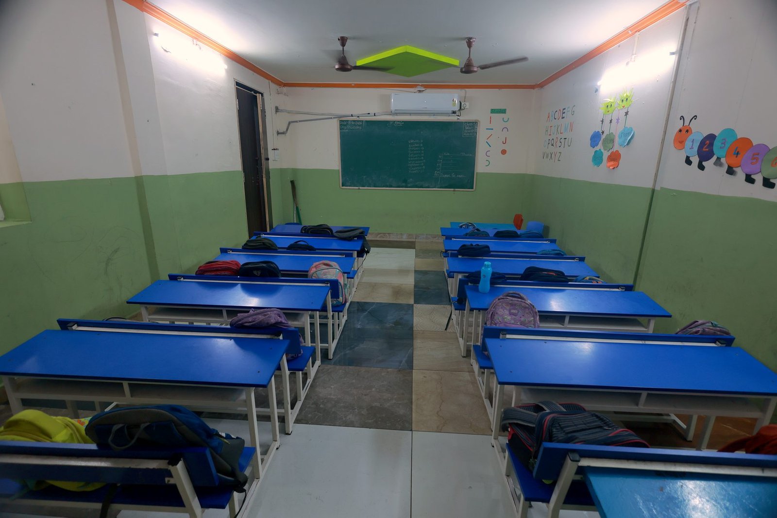 A bright classroom with blue desks