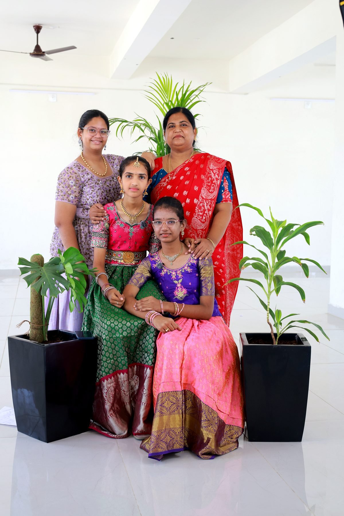 A teacher with students in traditional dress