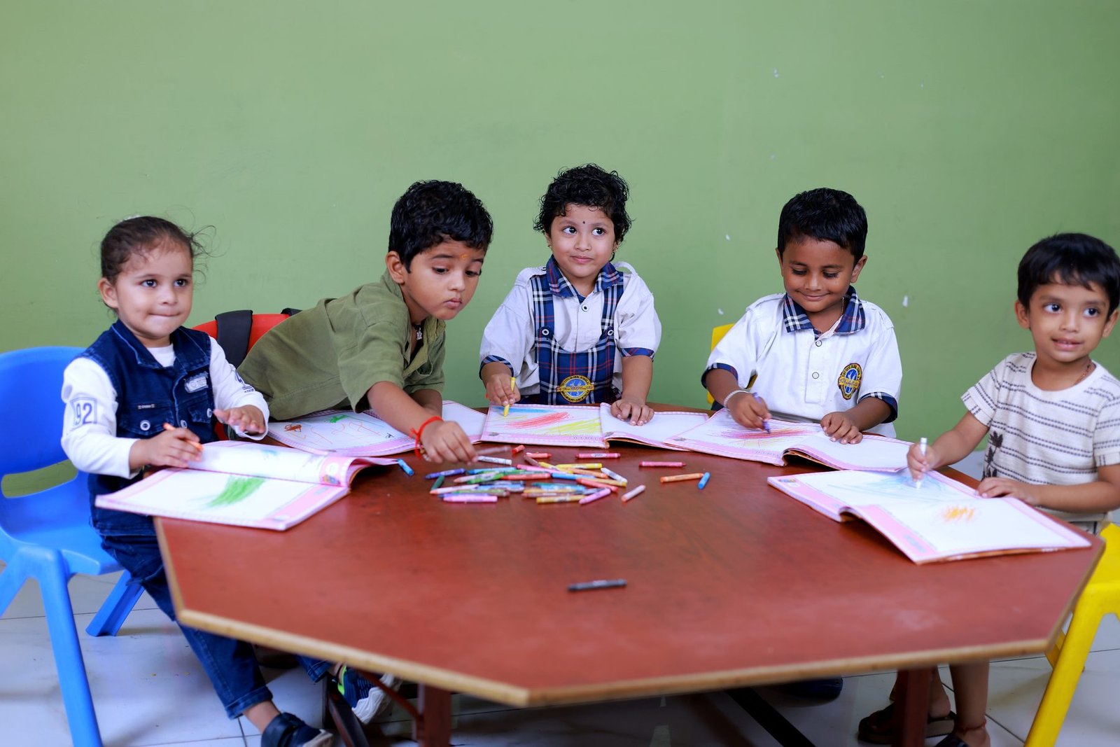 Preschool children colouring together